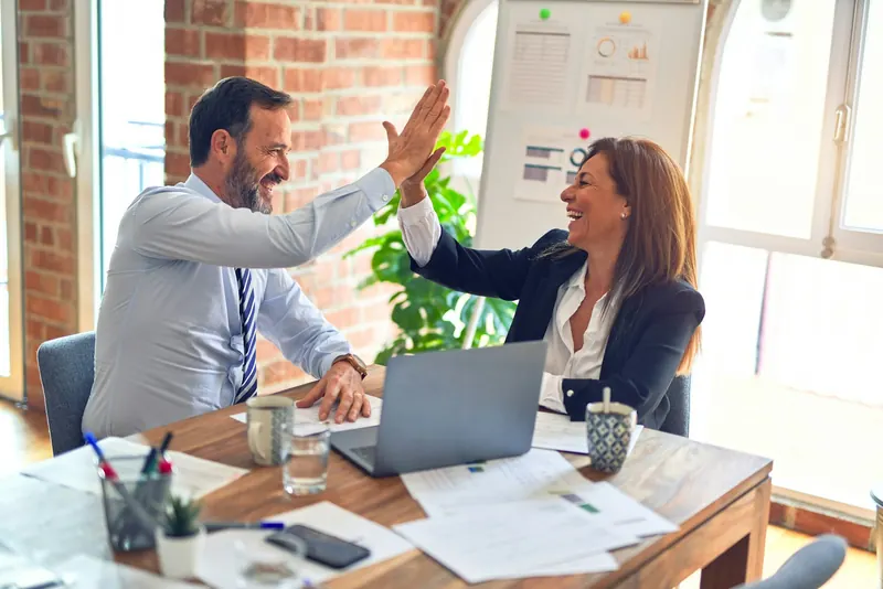 Two business partners celebrating a successful project